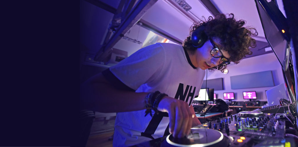 college student using DJ equipment